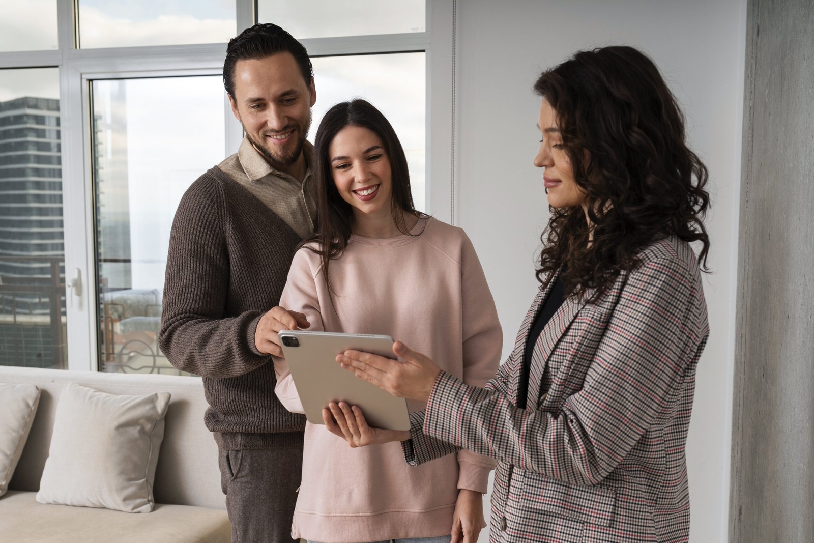 A couple purchasing a house with an agent, discussing details about their new home.
